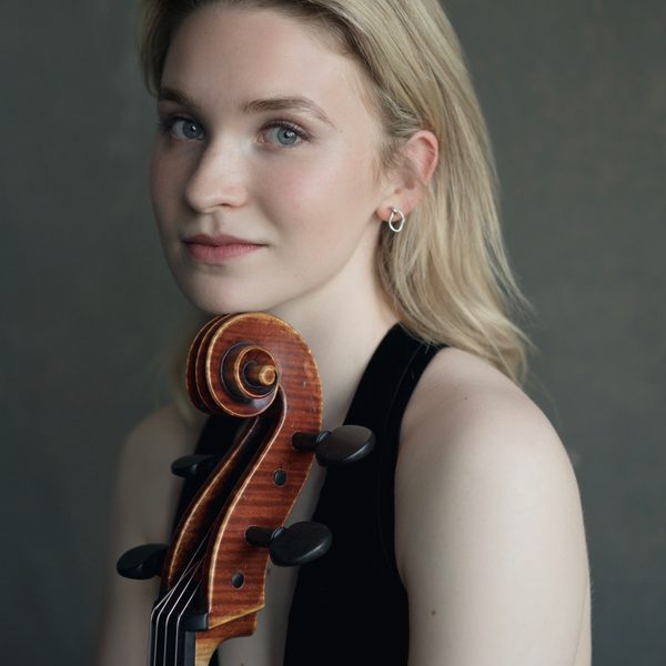Sophie Kauer poses for camera with a cello.