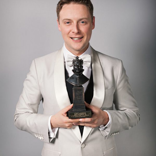 Stephen Ashfield holds an Olivier Award.