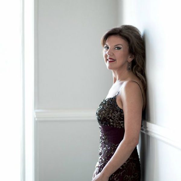 Tamsin little stands against a wall, looking side-on to camera.