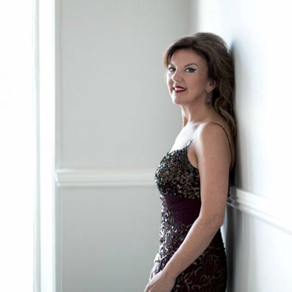 Tamsin little stands against a wall, looking side-on to camera.