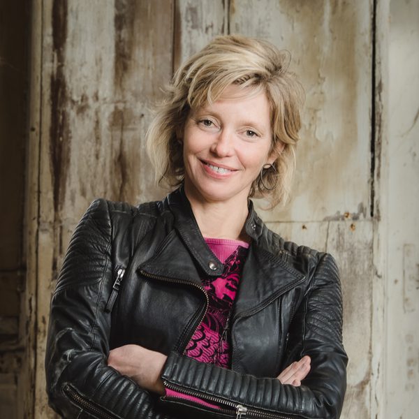 Tansy Davies smiling to camera.