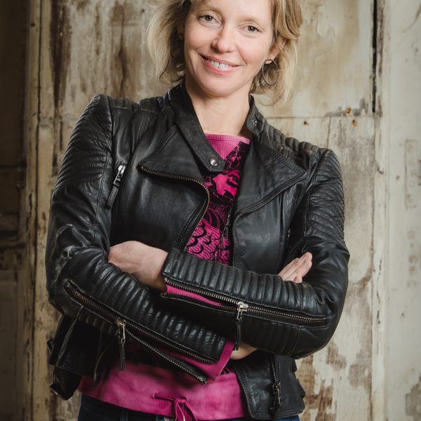 Tansy Davies smiling to camera.