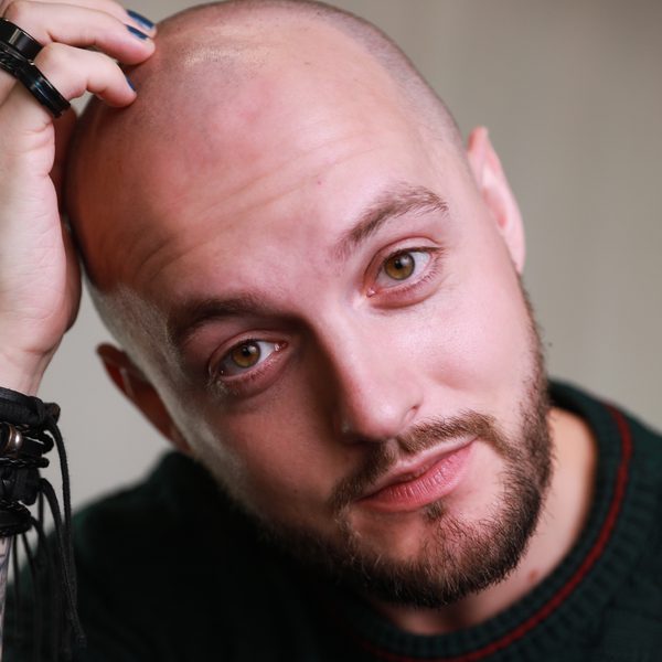 Close up of Tom Reade, posing for headshot, facing camera.
