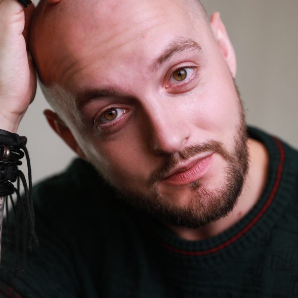 Close up of Tom Reade, posing for headshot, facing camera.