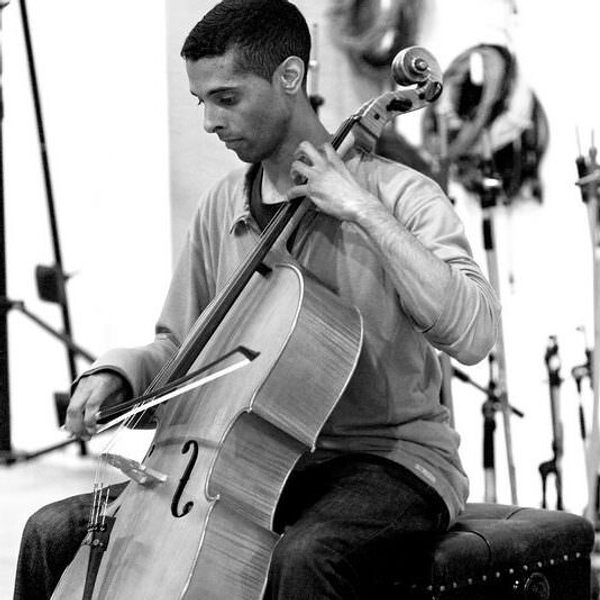 Tony Woollard plays cello in a monochrome image.