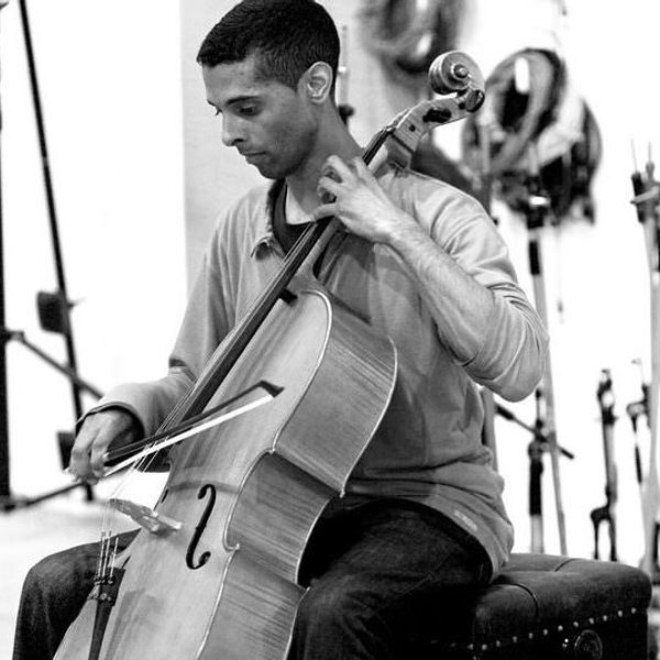Tony Woollard plays cello in a monochrome image.