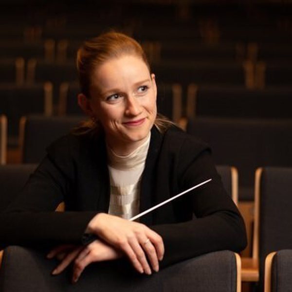 Portrait of Tori Longdon holding a conductor's baton.