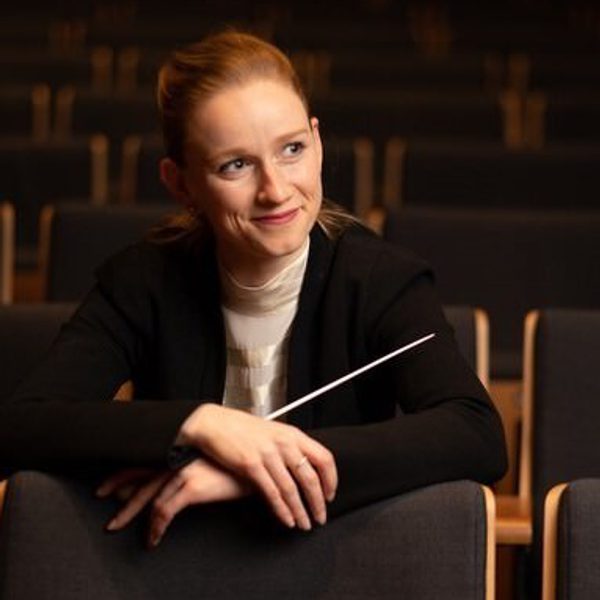 Portrait of Tori Longdon holding a conductor's baton.