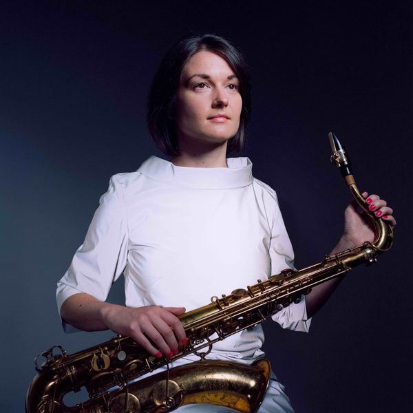 Trish Clowes holding a saxophone.