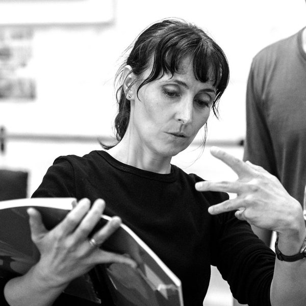 Victoria Newlyn gesticulates while reading from sheet music.