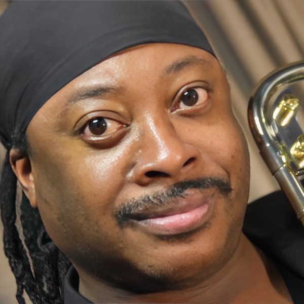 A close-up of Winston Rollins holding a trombone.