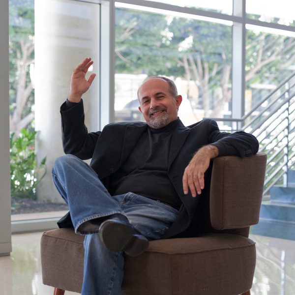 Yehuda Gilad sits in a chair in conversation.