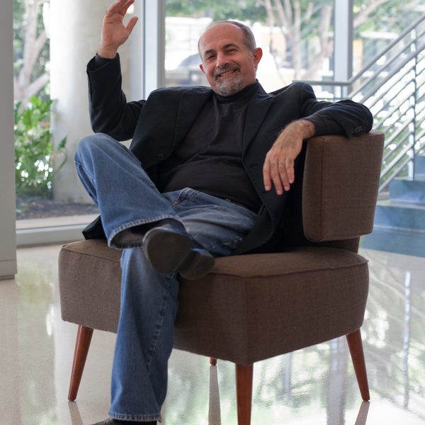 Yehuda Gilad sits in a chair in conversation.