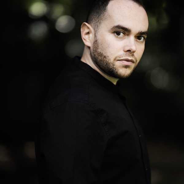 Portrait of conductor Ben Glassberg outside, facing camera