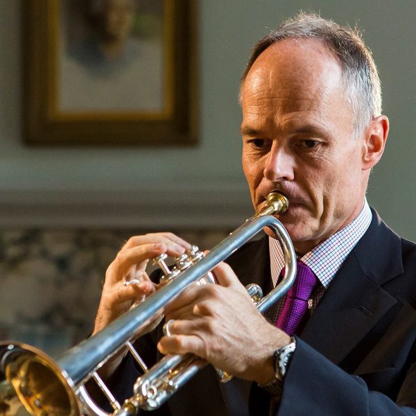 Mark David plays a trumpet