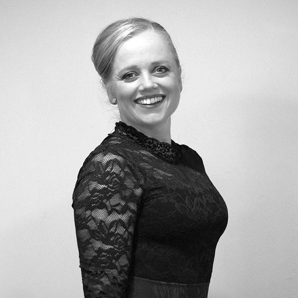 Side portrait of Kate Paterson in concert dress, smiling for camera